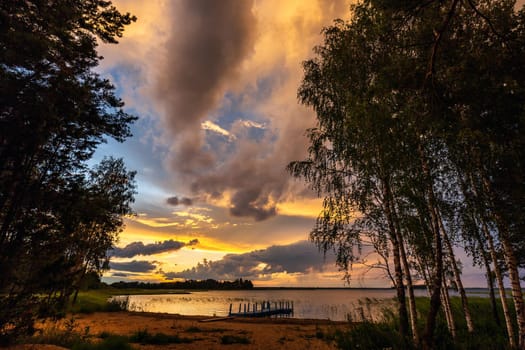 Amazing sunset at the Braslaw lakes with the cloudy sky. Braslaw district, Belarus.