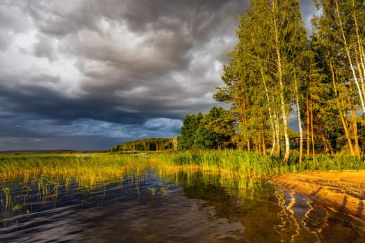 Amazing sunset at the Braslaw lakes with the cloudy sky. Braslaw district, Belarus.