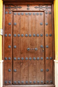 Old colorful carved wooden door in a small village in Castilla La Mancha community, Spain