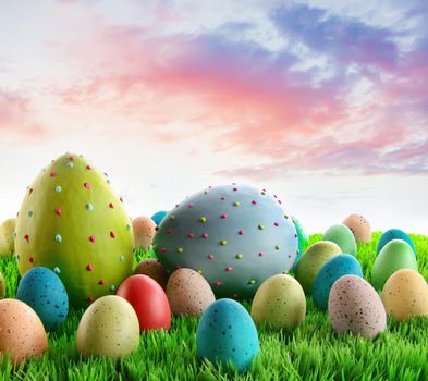 Colorful decorated eggs in the grass with sky in background