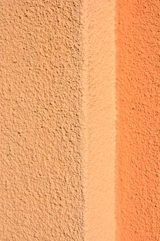 Detail of an orange painted rough wall