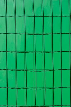 Detail of metal fence painted in green