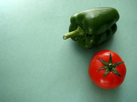 Ripe vegetables. Red tomato and green bell pepper, close-up, isolated. High quality photo