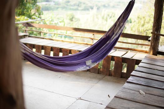 hammock cradle for relaxing on terrace near garden. cozy lifestyle at home