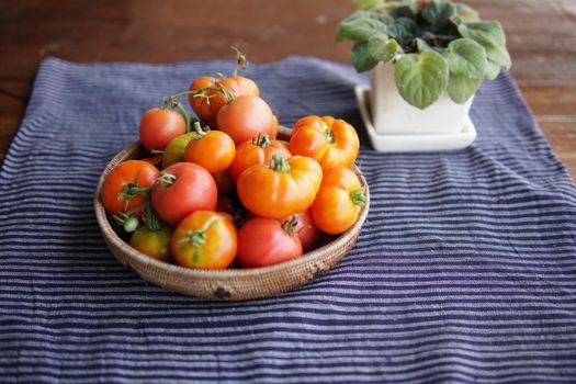 fresh raw red tomatoes in basket on table