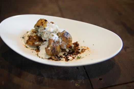 baked roasted potatoes with sour cream sauce and herb