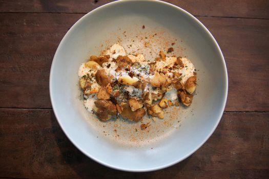 baked roasted potatoes with sour cream sauce and herb