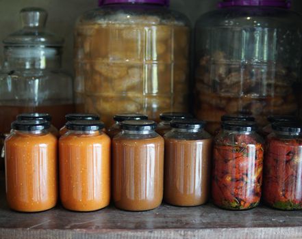tomato paste and sun dried tomatoes marinated in olive oil in glass jar