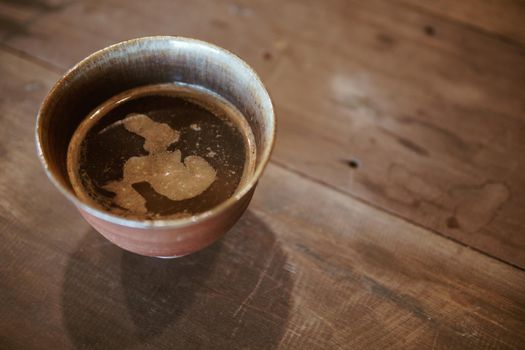 espresso cowboy coffee in ceramic cup on wooden table