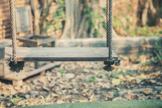 wooden swing for relaxing in garden park