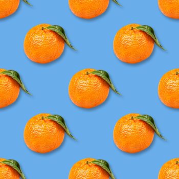 Christmas seamless background from ripe tangerines isolated on blue