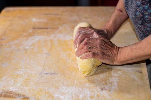 grandmother preparing homemade dough dough with flour and eggs