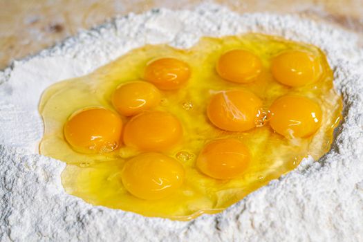 grandmother preparing eggs for homemade pasta dough