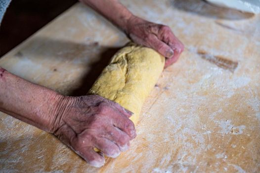 grandmother preparing homemade dough dough with flour and eggs