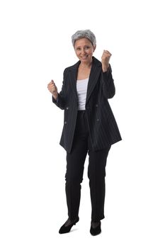 Full length portrait of happy beautiful mature asian woman holding fists isolated on white background, business people