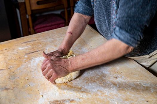 grandmother preparing homemade dough dough with flour and eggs