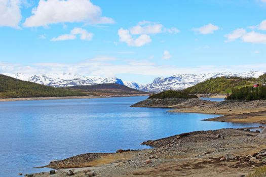 Spring arctic landscape with mountains, lake and tundra, sunny day, Mosvatn, Norway