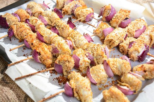 finger food skewers of fish and onion au gratin baked with chopped bread