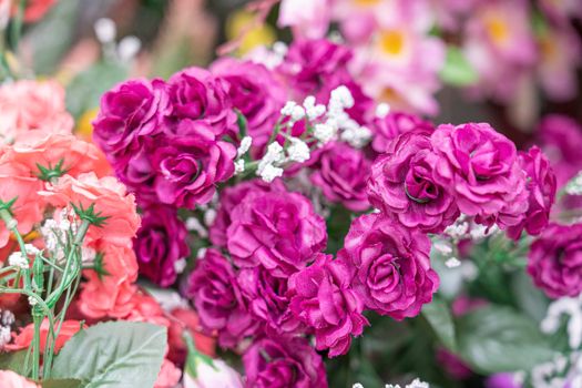 artificial multicolored flowers close up as background. High quality photo