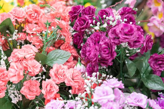 artificial multicolored flowers close up as background. High quality photo