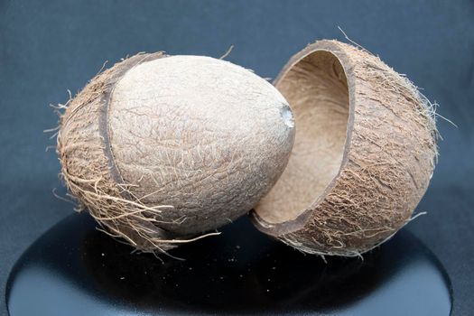 Cracked coconut with pulp on a gray background.Coconut close-up.