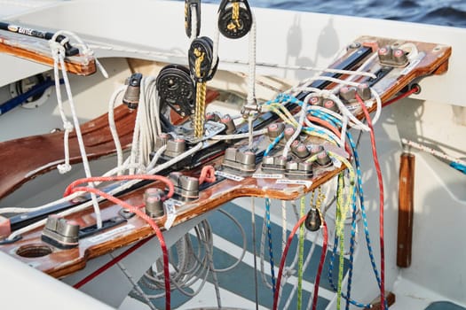 Set of ropes for management of the sailboat of different color, the signature to each rope, rollers, levers, carbines, clamps, the dragon sailboat. High quality photo