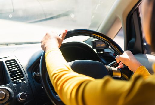 Asian woman while driving the car in the morning during going to work on highway road, Transportation and vehicle concept