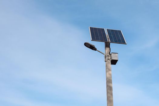 solar panel on a lamppost against the blue sky on a bright sunny day. Street lighting with solar panels. copy space