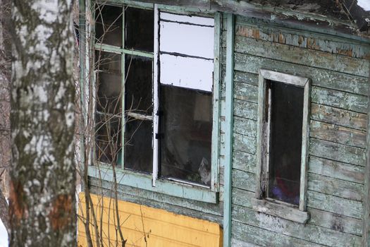 Abandoned wooden house. An old house in a village with no windows. High quality photo