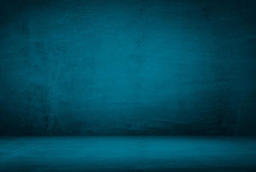 Vintage grunge blue concrete texture studio wall background with vignette