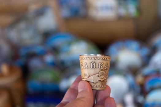 A glass with the image of a seal on birch bark. Baikal souvenir