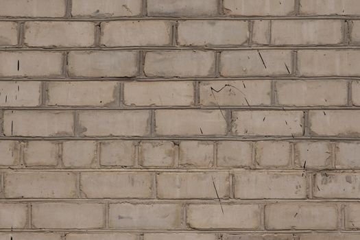 White old brick wall, close-up. The view from the street. texture