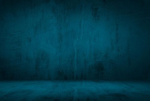 Vintage grunge blue concrete texture studio wall background with vignette