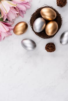 Design concept of Golden and silver Easter eggs in the nest with pink lily flower on bright marble white table background.