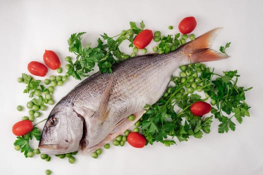Close up of freshwater seafood, garnished with cherry tomatoes, fresh peas and parsley leaves on a flat surface.
