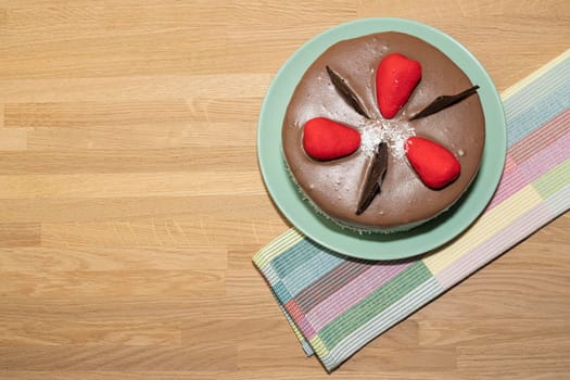chocolate cake and towel on wooden background. High quality photo