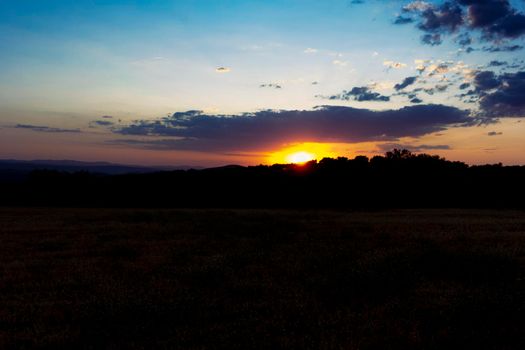 Backlit sunset with yellow, red and blue colors in southern Andalusia, Spain