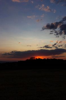 Backlit sunset with yellow, red and blue colors in southern Andalusia, Spain