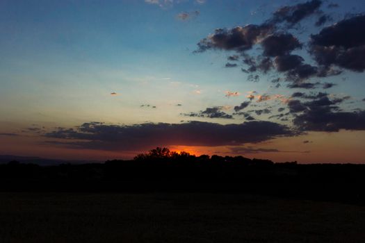 Backlit sunset with yellow, red and blue colors in southern Andalusia, Spain