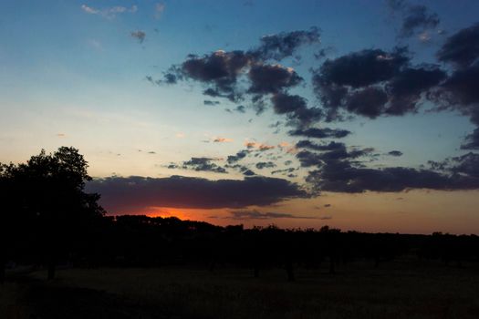 Backlit sunset with yellow, red and blue colors in southern Andalusia, Spain