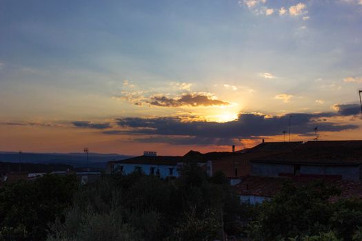 Backlit sunset with yellow, red and blue colors in southern Andalusia, Spain