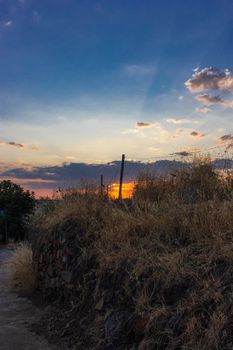 Stone wall in a field in Andalusia with a sunset sky in Spain