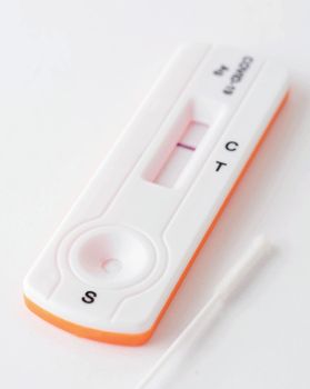 Home antigen test with swab for capturing of COVID-19 antibodies on white background. It shows negative result. 