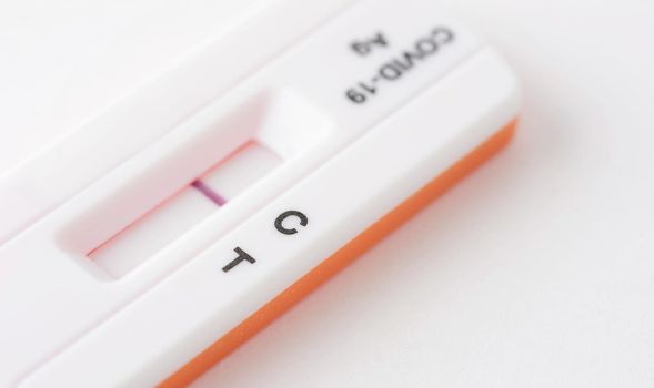 Home antigen test for capturing of COVID-19 antibodies on white background. It shows negative result. 
