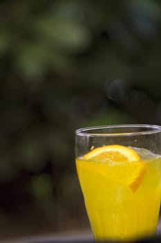 Orange soda in a crystal glass with a piece of natural orange. No people