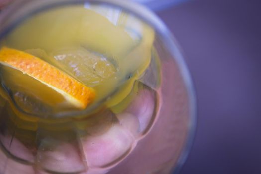 Orange soda in a crystal glass with a piece of natural orange. No people