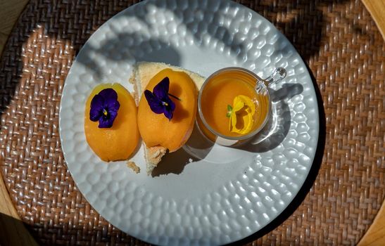 Traditional sweet dessert : Mayomgchid cheesecake on white plate. Delicious seasonal breakfast, Top view, Selective focus.