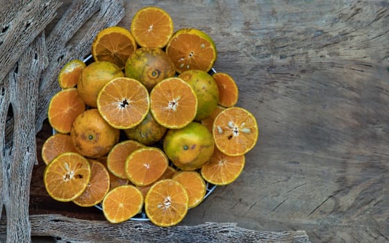 Fresh orange fruits on the old wooden table. Tangerine Phurua species, Juicy orange sour and sweet, healthy fruits, Copy spce, Selective focus.