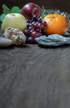Variety of fresh assorted fruits on the old wooden table. Assorted fruits colorful background, healthy fruits, Dark tone, Copy space, Selective focus.