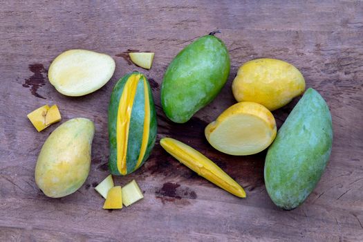 Variety of fresh mango on the old wooden table. fruits background, healthy fruits, Copy spce, Selective focus.